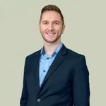 A person in a suit Description automatically generated